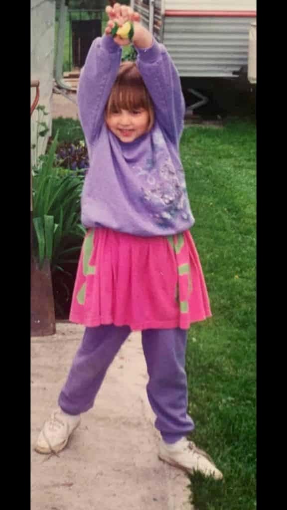 Young girl aged 5 outside striking a cute pose