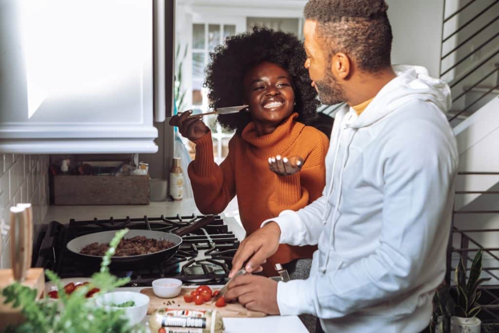 Woman and man cooking in the kitchen together.