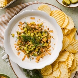 Protein Fried Pickle Dip in a white bowl with chips.
