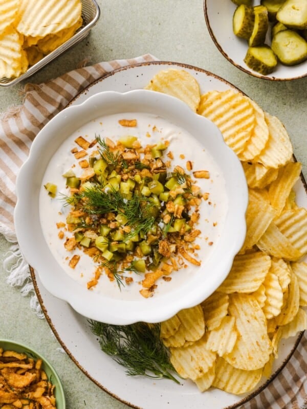 Protein Fried Pickle Dip in a white bowl with chips.