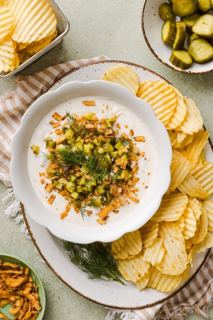 Protein Fried Pickle Dip in a white bowl with chips.