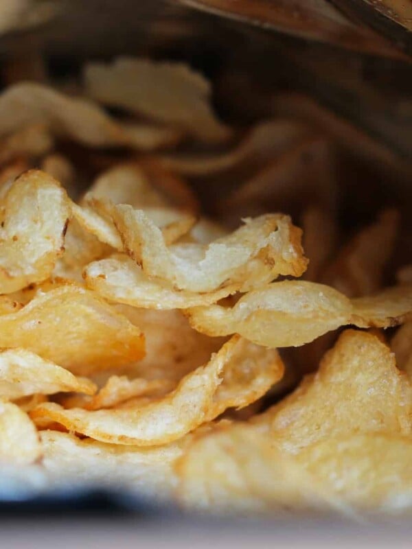 Close-up photo of a bag of potato chips laying open.
