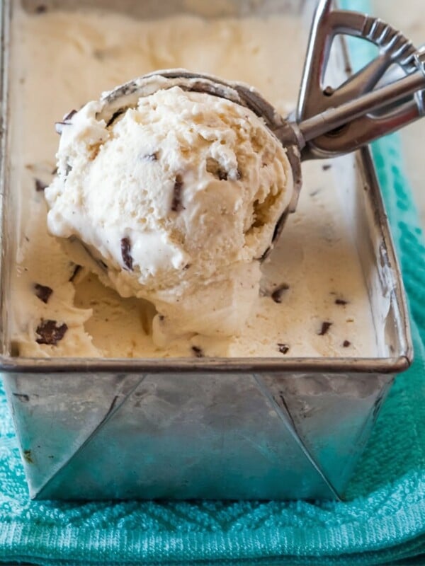 ice cream being scooped out of a silver cake tin