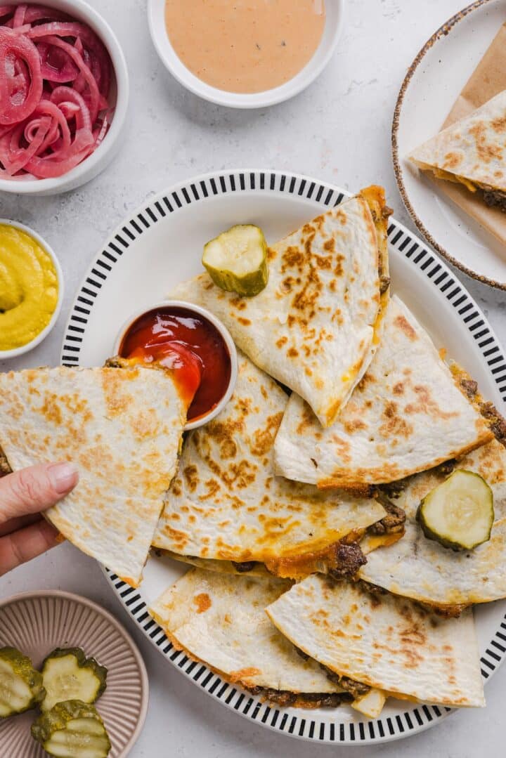 Cheeseburger quesadillas sliced and plated with Ketchup.