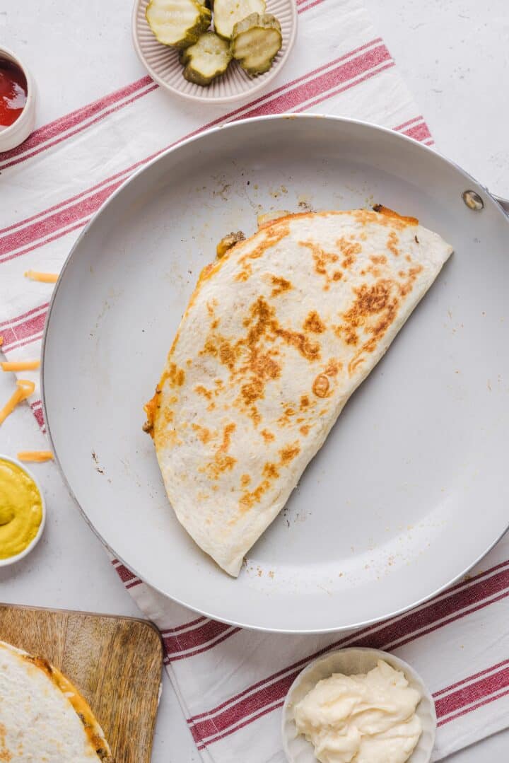 Cheeseburger quesadilla folded in a pan