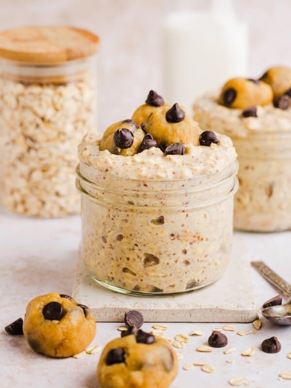 Cookie dough overnight oats with protein in a glass jar, topped with chocolate chips.