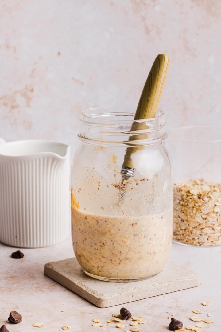 Stirred cookie dough overnight oats in a glass jar.