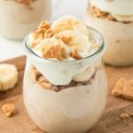 Three jars of protein banana pudding layered in glass jars.