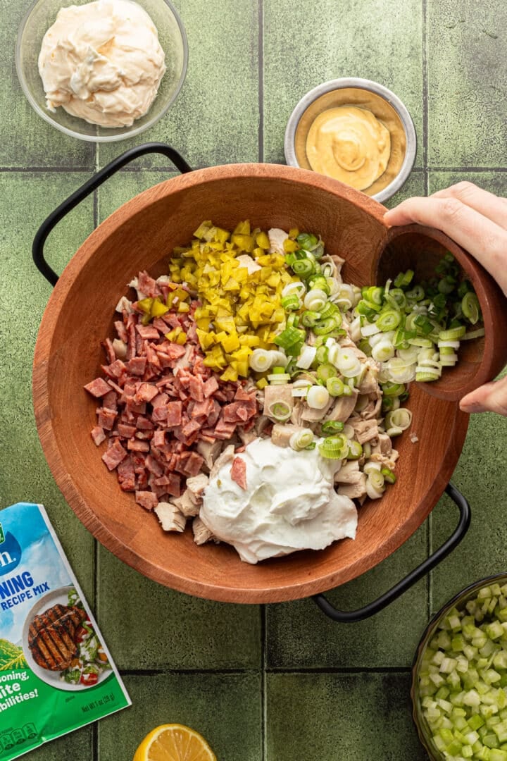 Ingredients for ranch chicken salad in a large wooden bowl