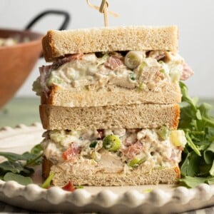 Ranch chicken salad in a sandwich, sliced in half.