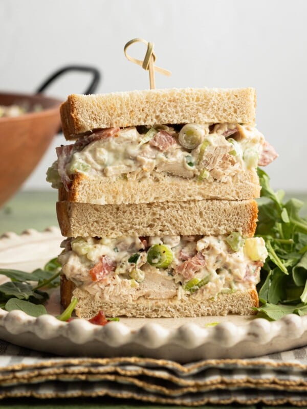 Ranch chicken salad in a sandwich, sliced in half.