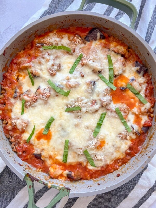 A large skillet with eggplant parmesan casserole