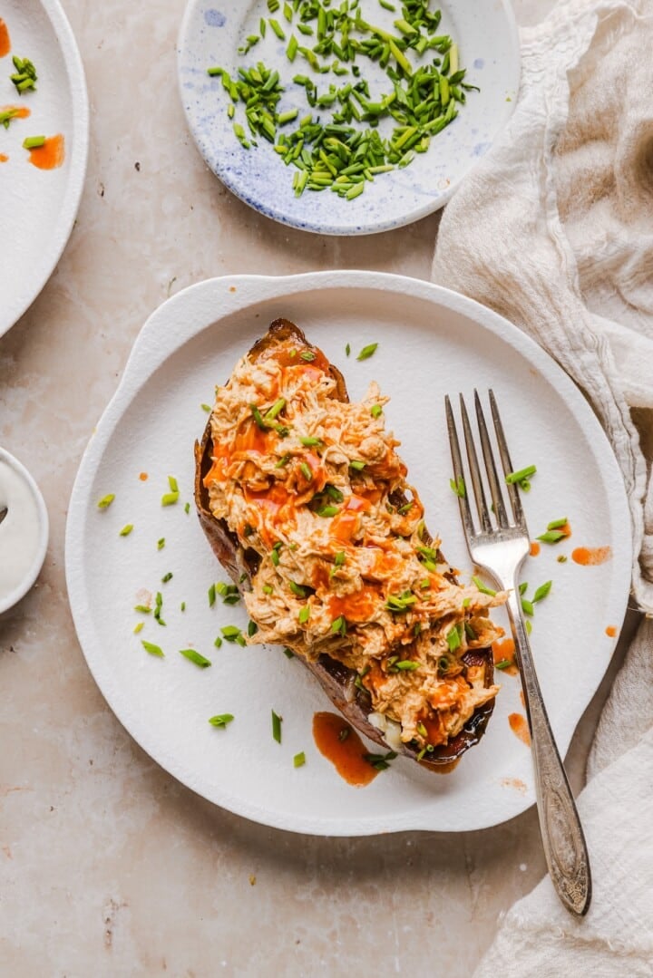 Sweet potato boats with shredded cheese, shredded buffalo chicken, and diced chives.