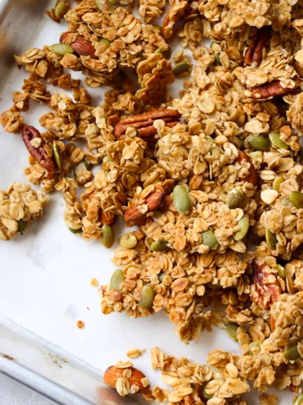 Salted honey nut granola clusters on a sheet pan