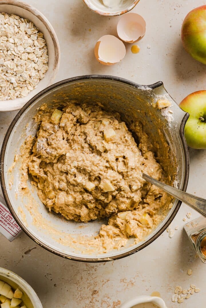 Batter for apple cinnamon oat muffins in a large mixing bowl.