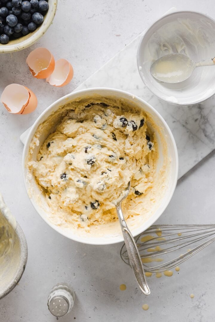 High protein blueberry muffin batter in a large white bowl.