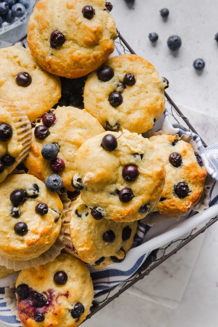 High-protein blueberry muffins in a large square basket.