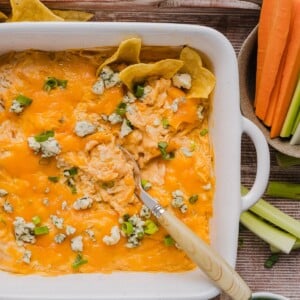 Creamy buffalo chicken dip with cottage cheese in a square baking dish.
