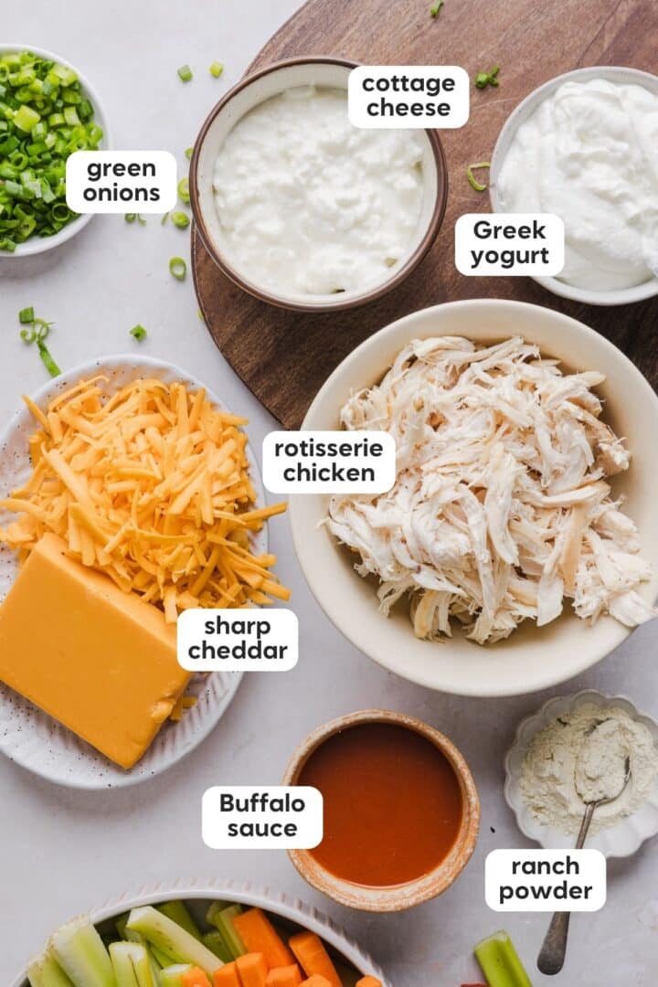 Ingredients for cottage cheese buffalo chicken dip on a marble counter.
