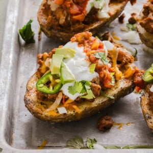 Stuffed taco baked potatoes on a sheet pan.