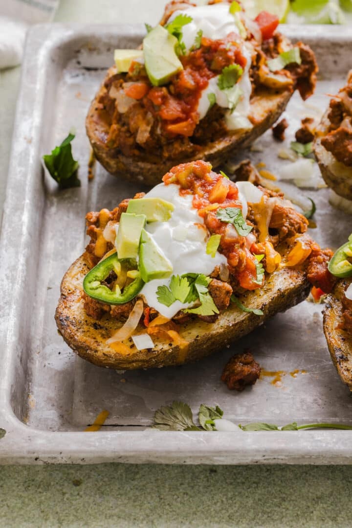 Stuffed taco baked potatoes on a sheet pan.