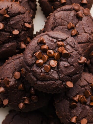 Close-up and overhead photo of brownie black bean muffins piled on a white plate