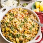 One pot pesto chicken and rice in a large white serving dish