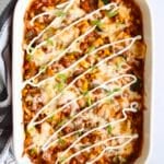 Turkey zucchini enchilada casserole in a 9x13 ceramic baking dish