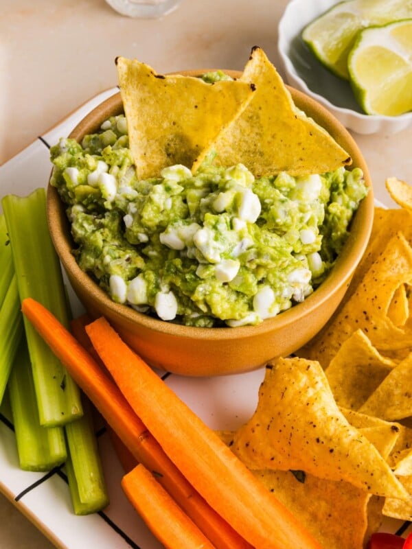 Cottage cheese guacamole served with tortilla chips and sliced vegetables