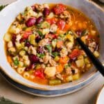 A small bowl of high protein minestrone soup with Italian sausage.
