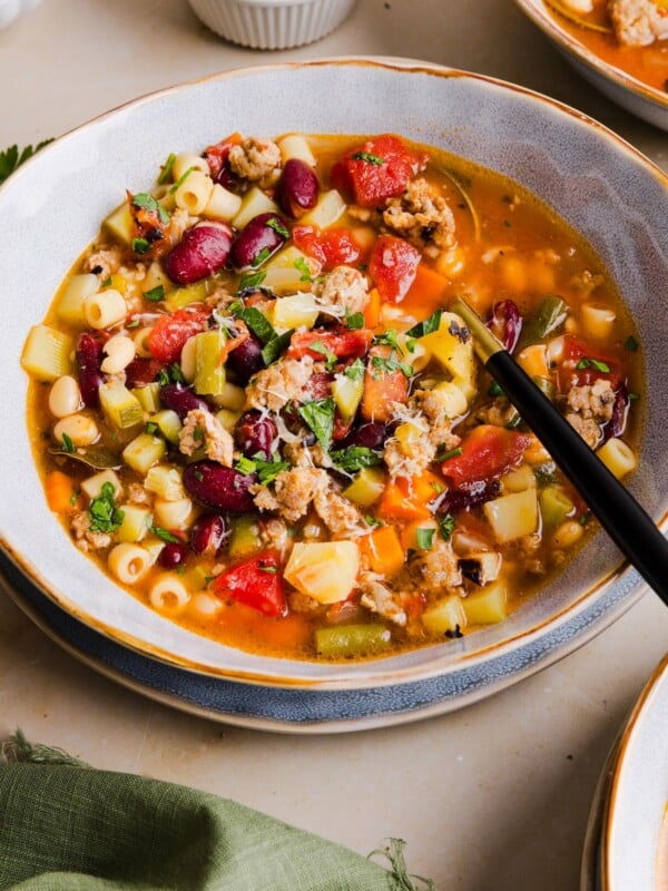 A small bowl of high protein minestrone soup with Italian sausage.