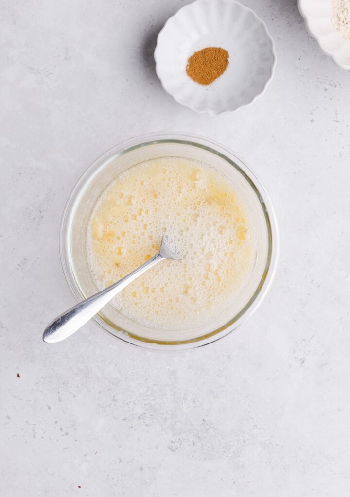 Egg whites and mashed banana mixed together in a small oven safe glass bowl
