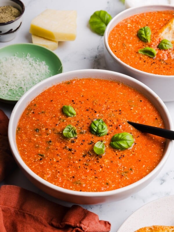 Big bowl of protein tomato soup garnished with basil leaves