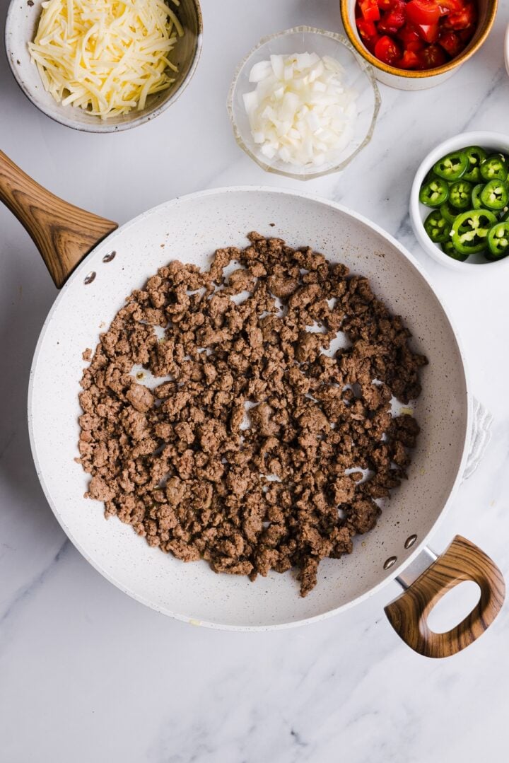 Beef browned and crumbled in a large pan