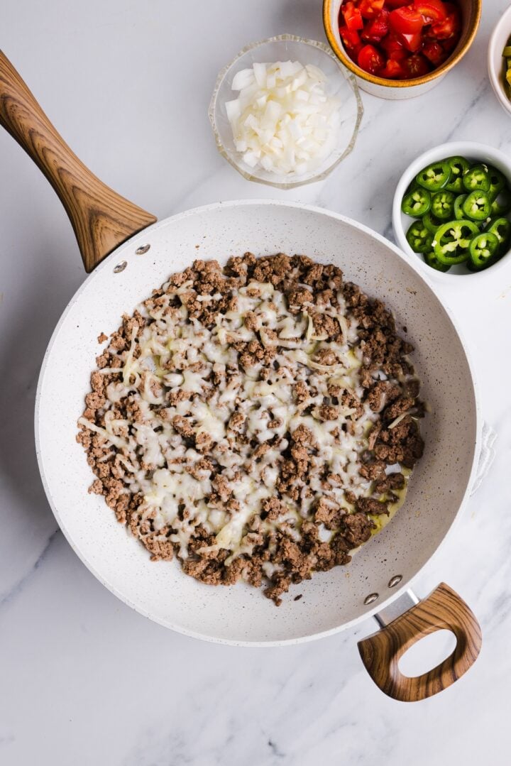 Beef topped with shredded cheese