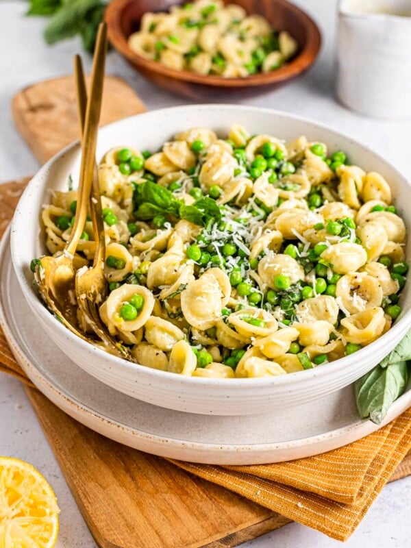 Bowl of lemon basil pasta salad with peas and parmesan cheese