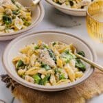 A few small bowls filled with one-pot chicken and artichoke pasta
