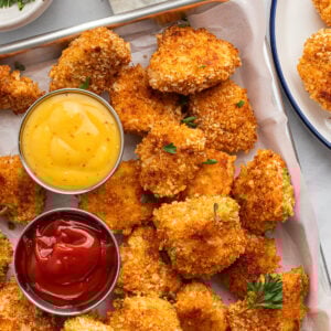 Overhead photo of baked, crispy, homemade panko chicken nuggets with mustard and ketchup