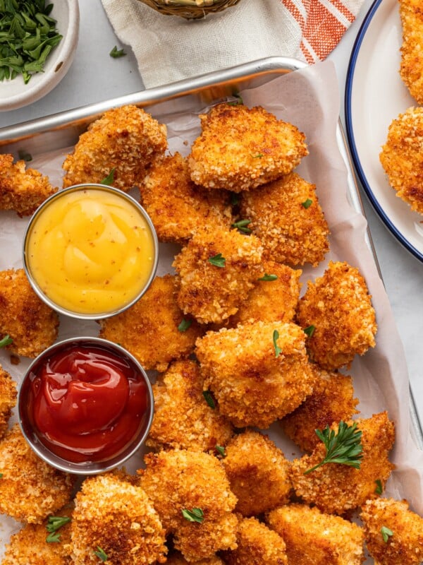 Overhead photo of baked, crispy, homemade panko chicken nuggets with mustard and ketchup