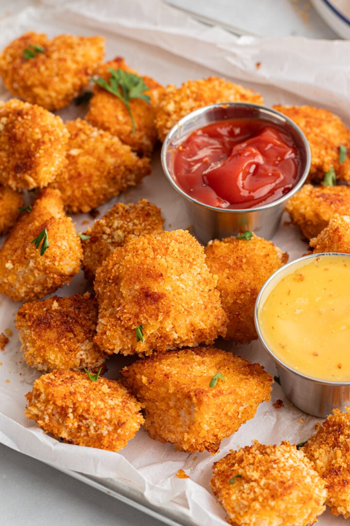 Sheet tray with homemade panko chicken nuggets with ketchup and honey mustard dipping sauce