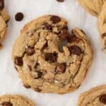 Chewy chocolate chip cookies on a parchment-lined sheet pan