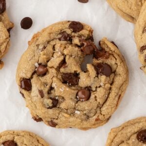 Chewy chocolate chip cookies on a parchment-lined sheet pan