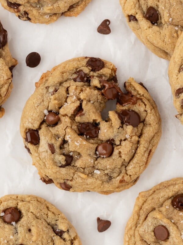 Chewy chocolate chip cookies on a parchment-lined sheet pan