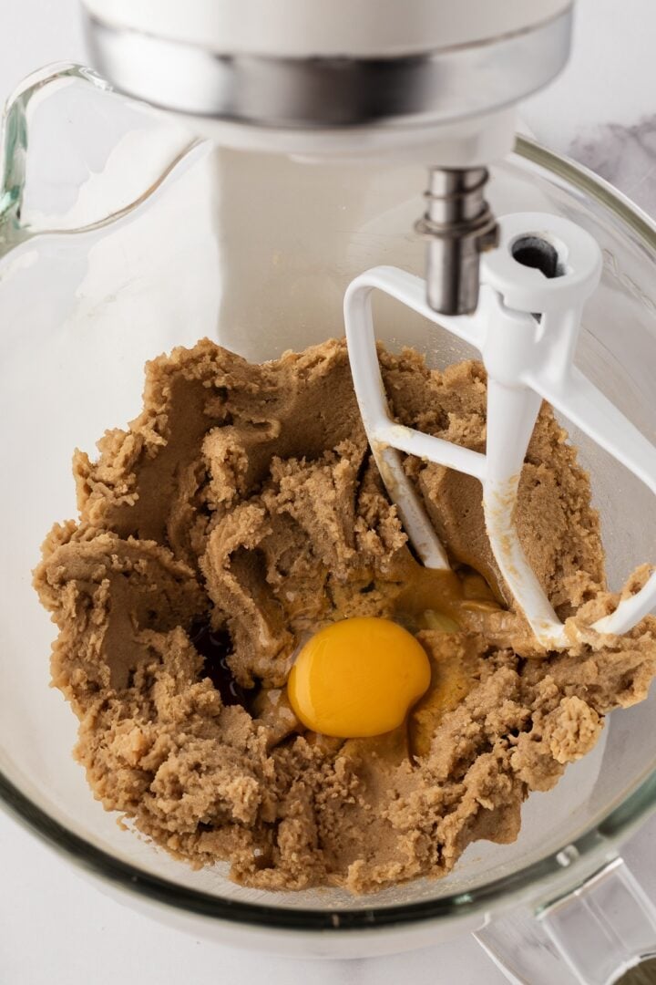 Eggs being added to cookie dough in a stand mixer