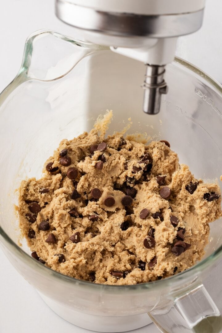 Chocolate chips mixed into cookie dough 