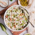 Overhead photo of jalapeno popper chicken salad in a white bowl, surrounded by other ingredients