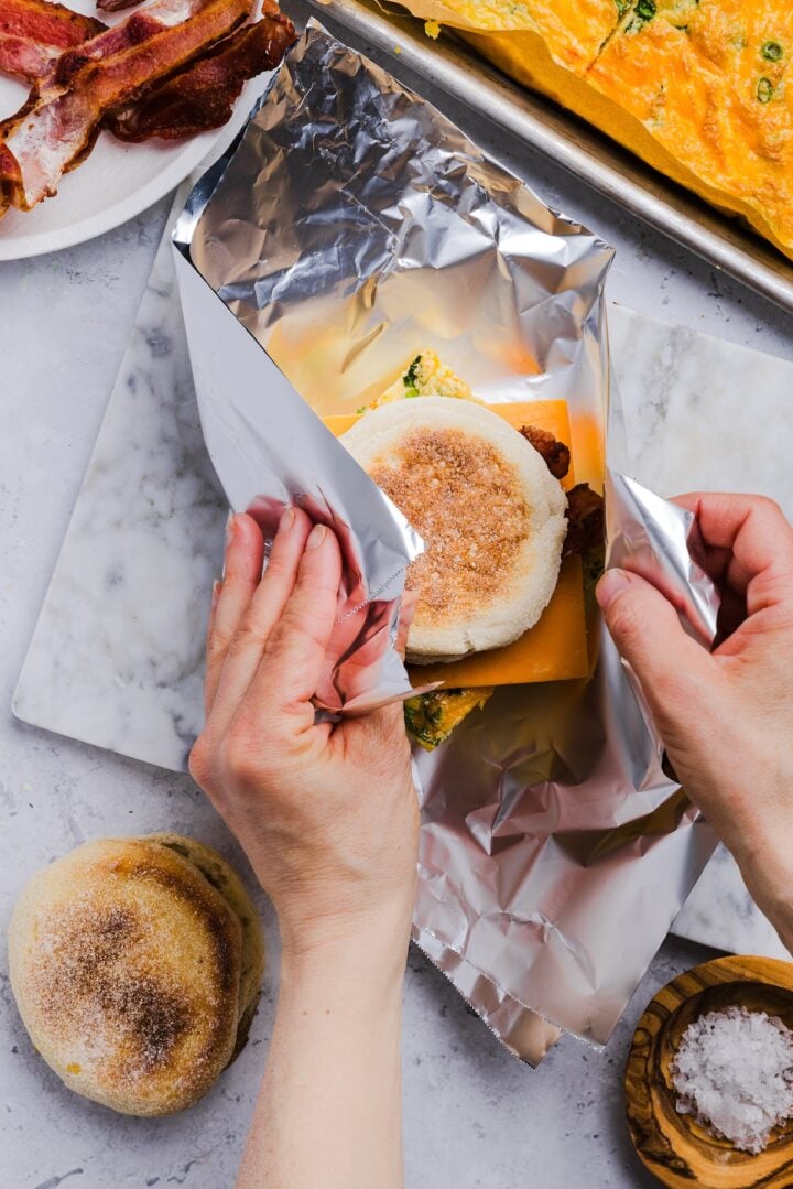 English muffin breakfast sandwich wrapped in aluminum foil