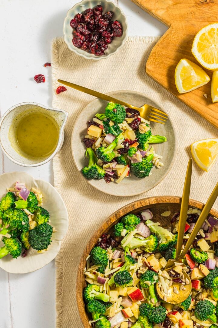 Broccoli crunch salad plated on a white tile kitchen counter