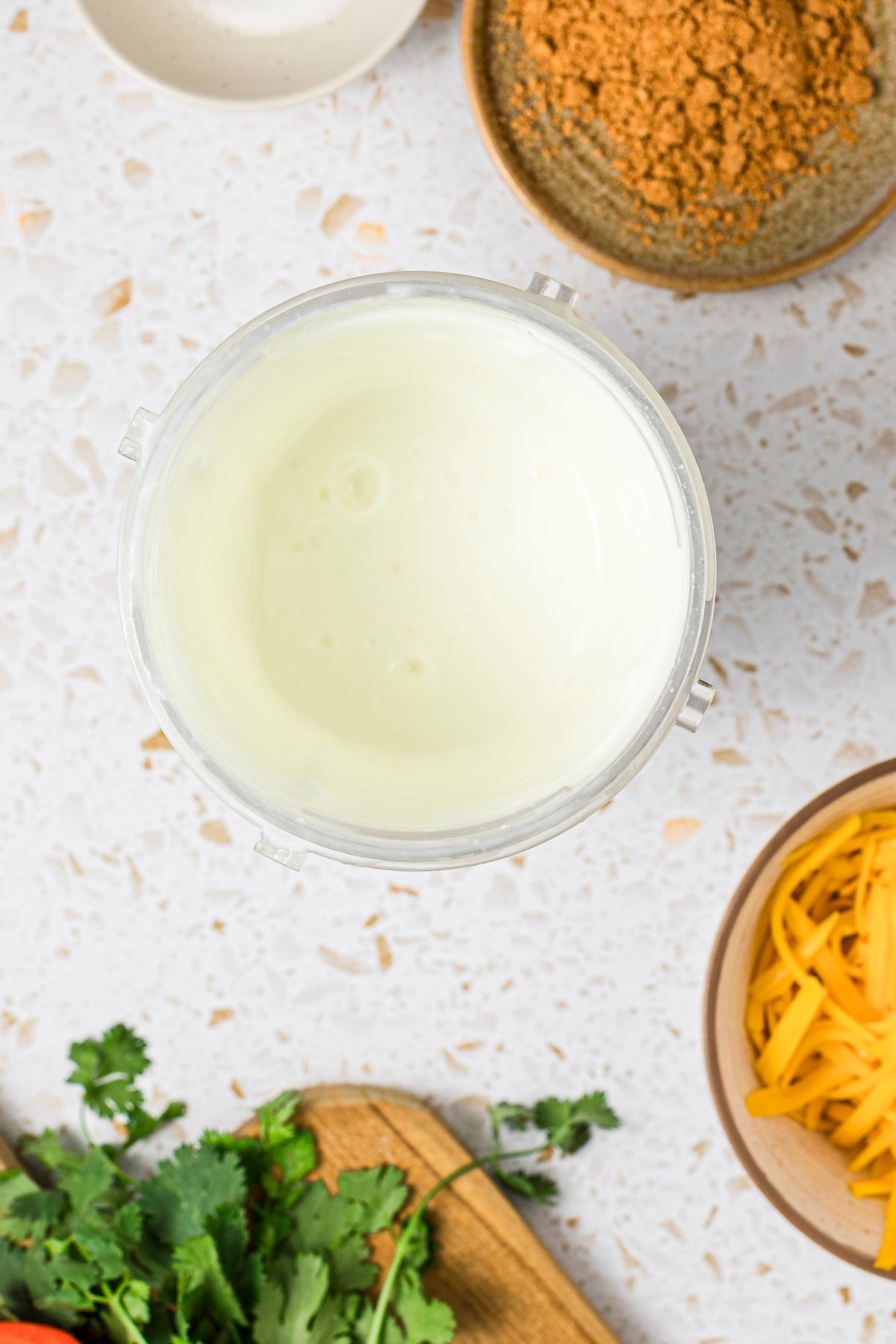 Cottage cheese blended in a small plastic blender cup.