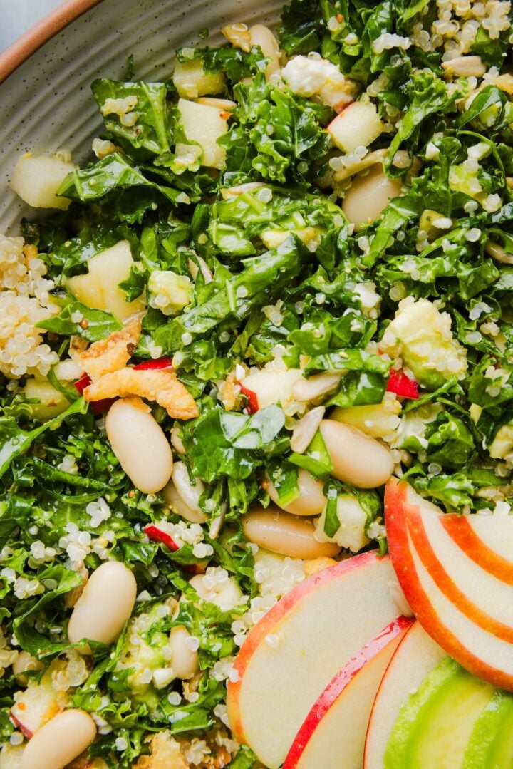 Kale white bean salad tossed in a mixing bowl.